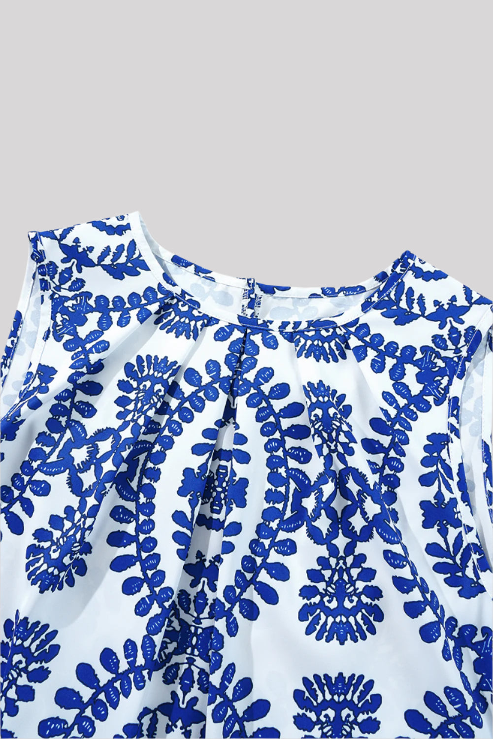 Sleeveless blue and white blouse