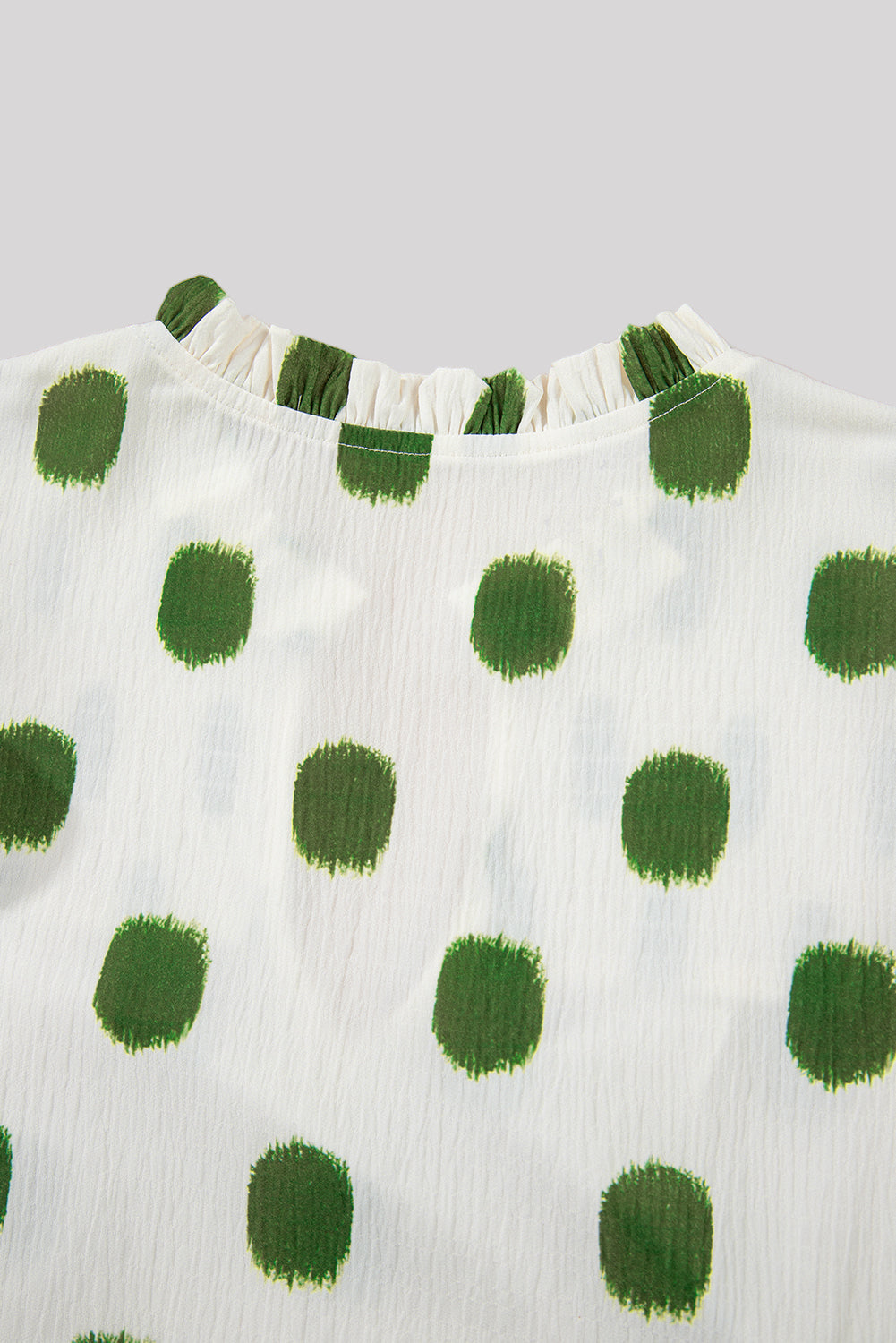 White & green polka dot blouse