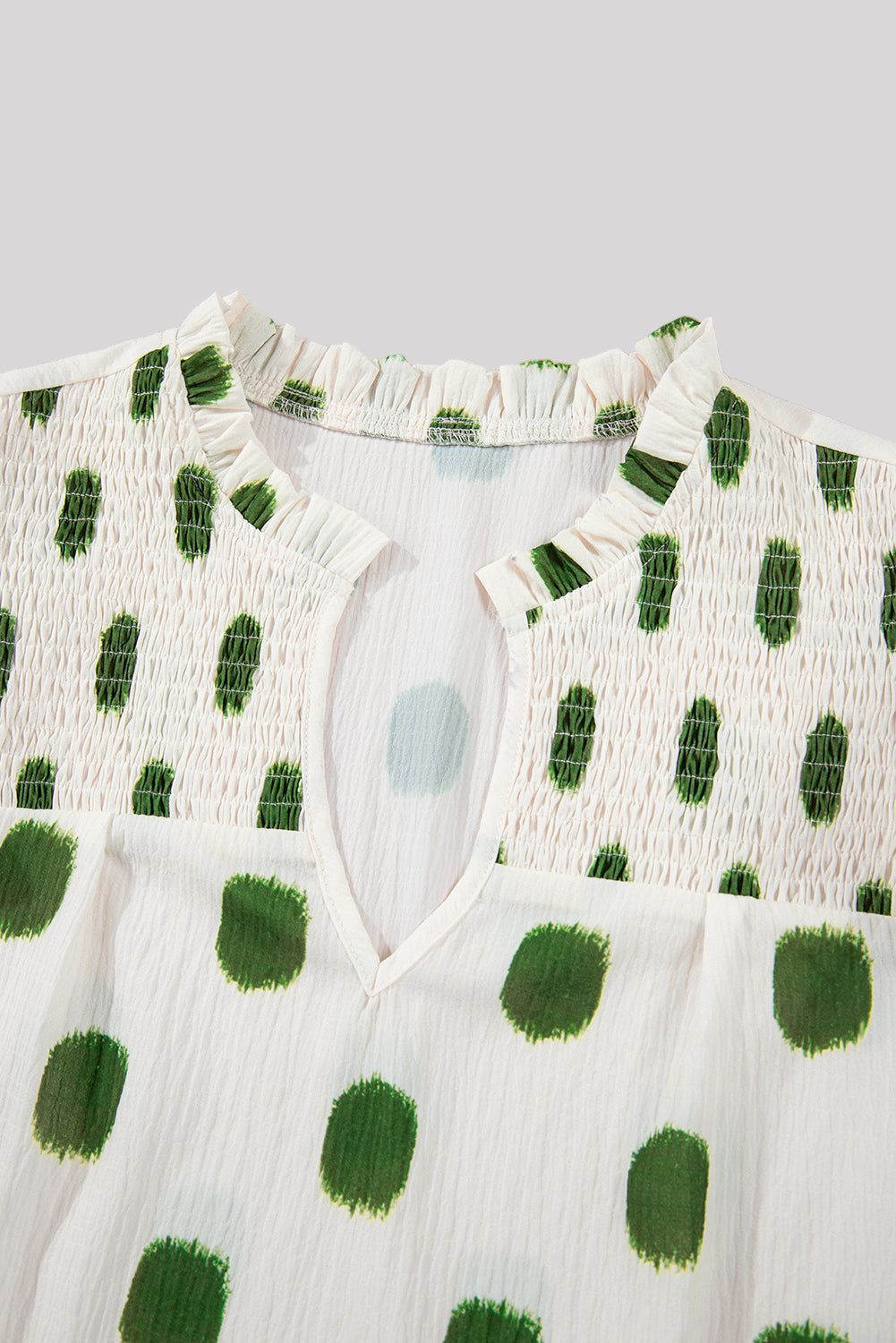 White & green polka dot blouse