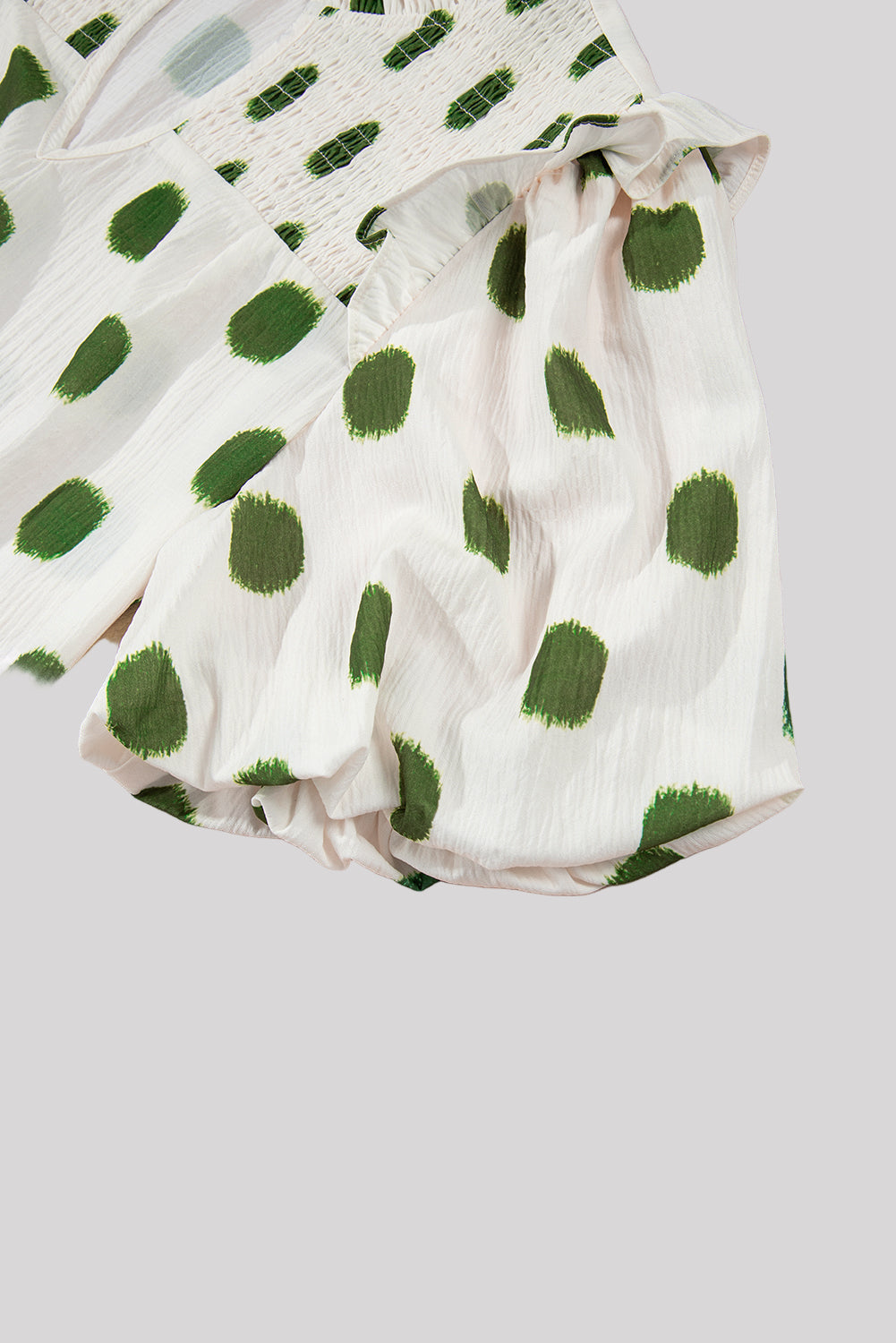 White & green polka dot blouse